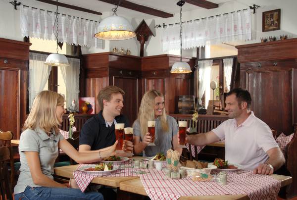 Menschen an einem Tisch im Restaurant die anstoßen Picture by Hotel & Brauereigasthof Drei Kronen
